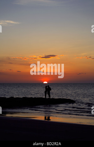 Young lovers enjoying the sunset over Holbox Island, Quintana Roo, Yucatán Peninsula, Mexico, a unique Mexican destination Stock Photo