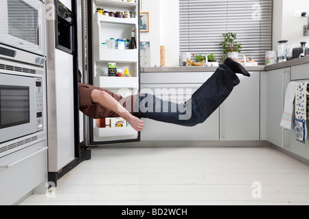 man looking in fridge Stock Photo