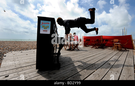 Man playing the piano on Worthing seafront beach Stock Photo