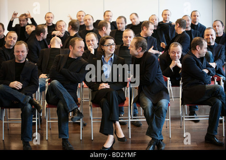 businesswoman surrounded by man 25 times Stock Photo