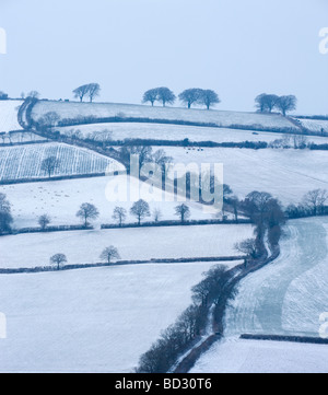 Snow covered winding country lane and rural landscape near Stockleigh Pomeroy Mid Devon England February 2009 Stock Photo
