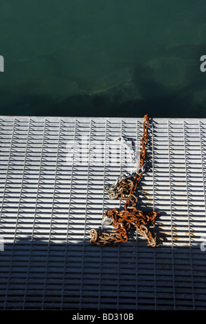 old rusty chain on metal pier in harbour by sea Stock Photo