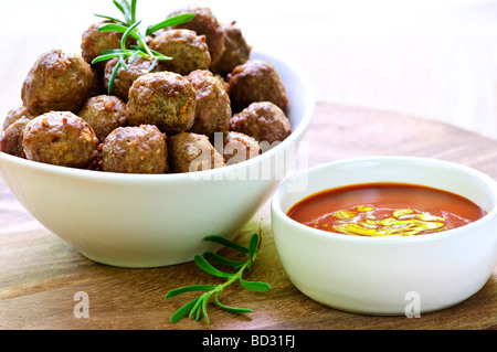 Fresh hot meatball appetizers served in white bowl with dipping sauce Stock Photo