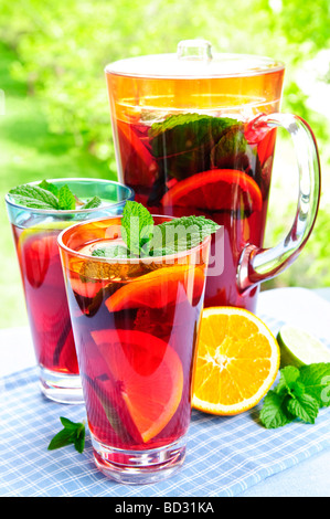 Refreshing fruit punch beverage in pitcher and glasses Stock Photo