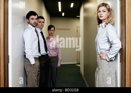 2 Women and 2 men in an office corridor Stock Photo