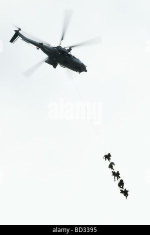 Soldiers descending from a helicopter on a rope, landing exercise of the airborne forces unit of the French military Stock Photo
