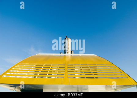 Yellow funnel with exhaust pipe of engine with blue sky Stock Photo