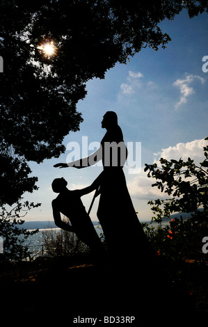 Statue depicting Jesus Christ and St Peter beside the Church of the Primacy of Tabgha at the western coast of the Sea of Galilee in northern Israel Stock Photo