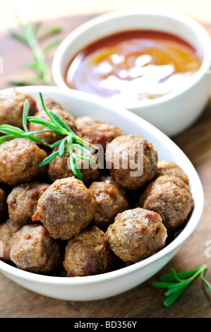 Fresh hot meatball appetizers served in white bowl with dipping sauce Stock Photo