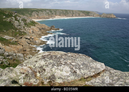 Porthcurno Bay near St Levan and Treen, with the Logan Rock in the distant background. Stock Photo