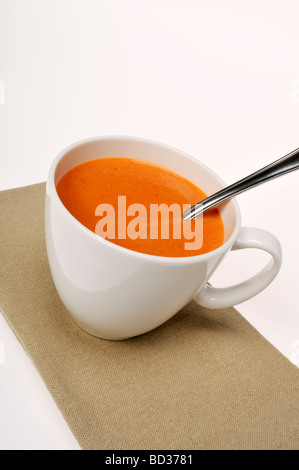 Cup of tomato soup with spoon and napkin Stock Photo