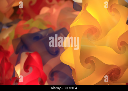 multicoloured plastic paper lanterns lampshades on market stall at night Stock Photo