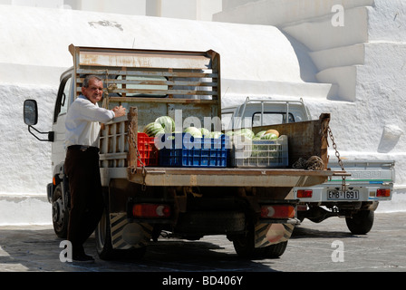 The watermelon delivery man and his truck parked near the Cathedral of Ios in the old town of Hora 'The Village'. Hora, Ios Isla Stock Photo