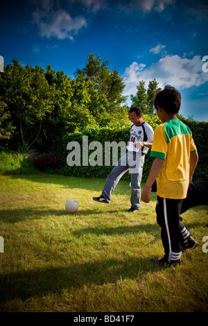 Father and Son playing Soccer in the Backyard, Netherlands Stock Photo
