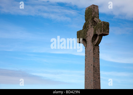 Celtic cross covered with moss and lichen, photographed on Iona, a small island in the Inner Hebrides group off western Scotland Stock Photo