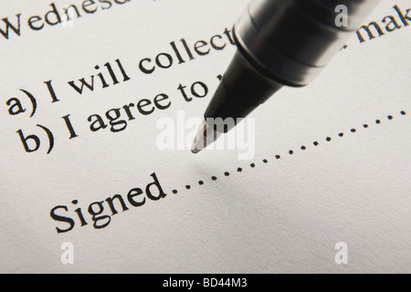 A pen poised to sign on the dotted line Stock Photo