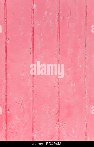 Closeup of wood panels with peeling pink paint Stock Photo