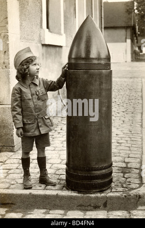 Little Girl Touching Artillery Shell Stock Photo