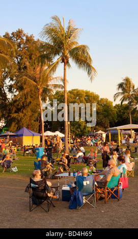 People sat around tables and chairs at Mindil Beach Market in Darwin, Australia Stock Photo