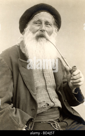 White Bearded Old Man Smoking Long Pipe Stock Photo