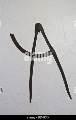 Antique metal compasses hanging on a white textured wall inside Quaker House, Dartmouth, Halifax, Nova Scotia, Canada. Stock Photo