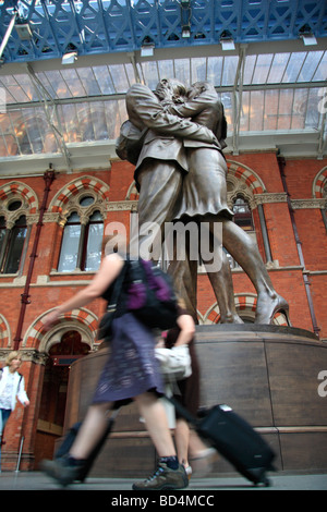 Passengers walk past 'The Meeting Place' by sculptor Paul Day, St Pancras International Railway Station, London, UK. Stock Photo