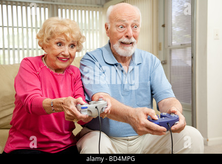 Senior couple having a great time playing video games  Stock Photo