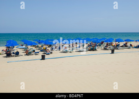 Sunbeds and Umbrellas on the beach at Rethymnon Crete Stock Photo