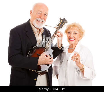 Senior man plays music on his mandolin while his wife sings along Isolated Stock Photo