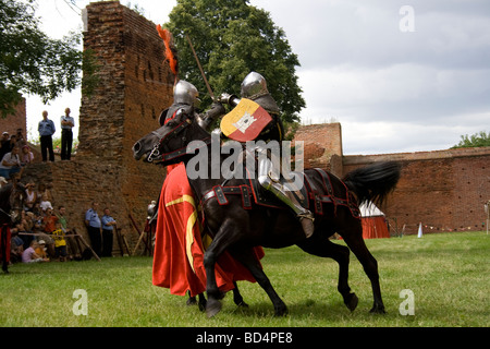 Medieval cavalry knights on military horses fighting with swords. Taken in Malbork, Poland, 2009. Stock Photo