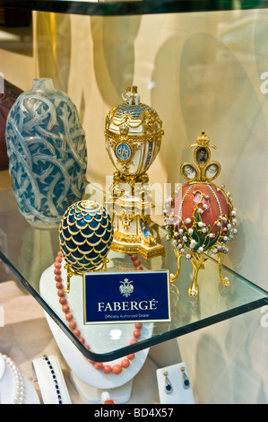 Modern Faberge eggs on a glass shelf at a luxury shop display in Manhattan, New York, USA. Features ornate designs and jewelry. Stock Photo