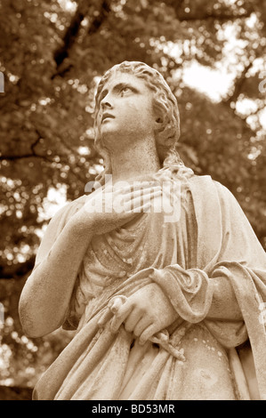 Eerie Cemetery statue of woman looking skyward toward the heavens Stock Photo