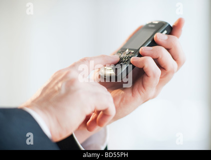 Businessman using personal digital assistant Stock Photo