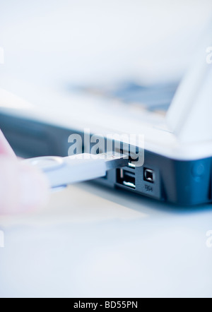A hand plugging in a universal serial bus Stock Photo