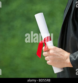 A graduate holding a diploma Stock Photo