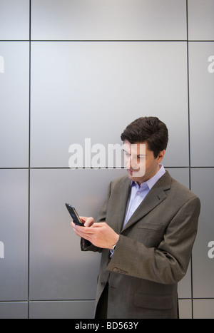 A businessman using a cellular phone Stock Photo