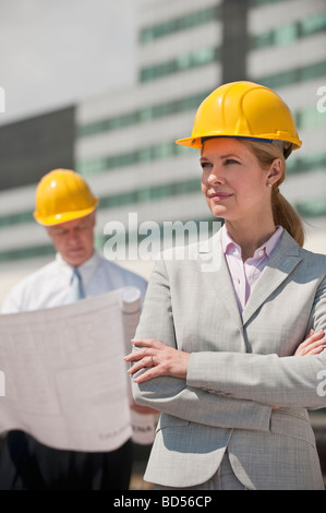 Two architects holding plans outdoors Stock Photo