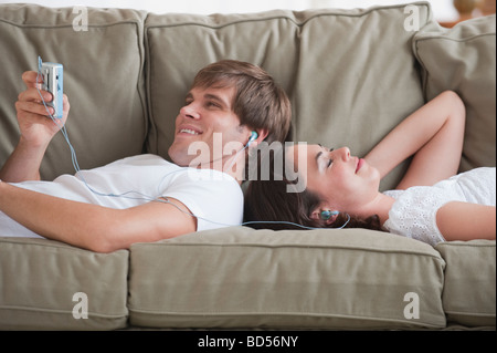 Couple in living room listening to music Stock Photo