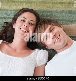 Couple lying in living room Stock Photo