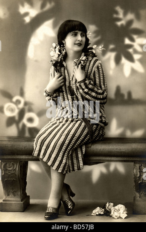 Woman in Striped Dress Seated on a Bench Stock Photo