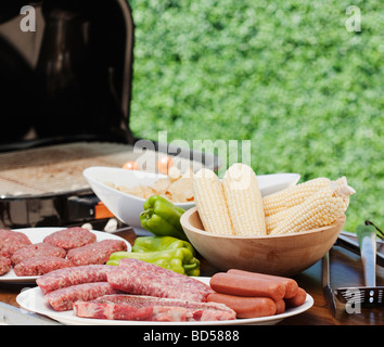 Corn and meats by a barbeque Stock Photo