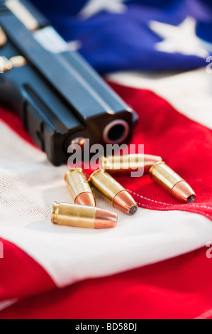 A handgun and ammunition on the American flag Stock Photo