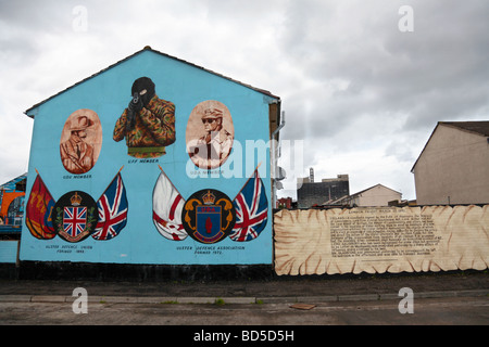 Belfast loyalist mural depicting three paramilitary organisations, UDU, UDA & UFF, with an extract from a newspaper report 1893 Stock Photo