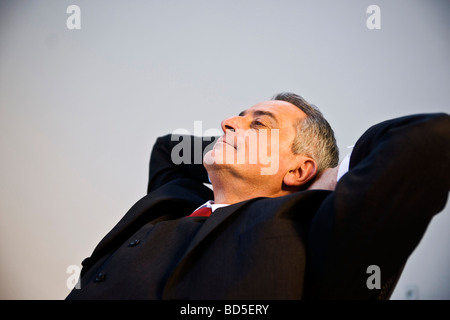 Manager relaxing in his desk chair Stock Photo