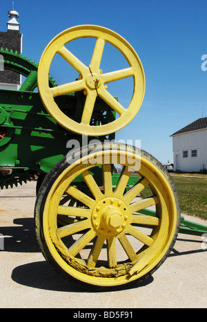 Wheels on an antique farm machine are painted in bright colors Stock Photo