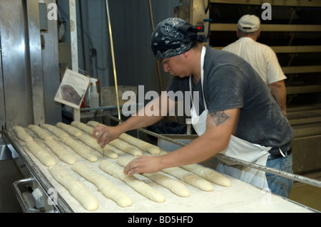 Workers at Amy s Bread in Chelsea Market in New York bake loaves of bread in the bakery s commercial ovens Stock Photo