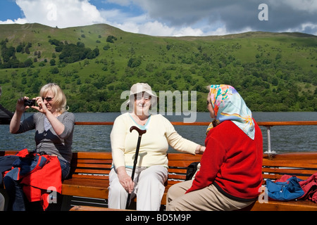 Passengers on a ferry on Ullswater, the Lake District, Cumbria, UK. Stock Photo