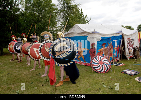 A group of Roman Reenactors with shields are shown performing at the Colchester Military Festival in Colchester, Essex, England Stock Photo