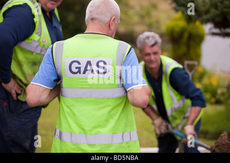 Workers from British Gas replacing old metal gas pipes with plastic piping in Ambleside Cumbria UK Stock Photo