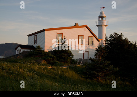 The Lobster Cove Head lighthouse lit by a setting sun Stock Photo